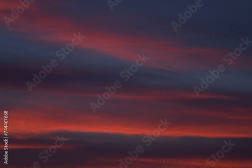 Fototapeta Naklejka Na Ścianę i Meble -  Dramatic sunset with vibrant clouds lit by a sun