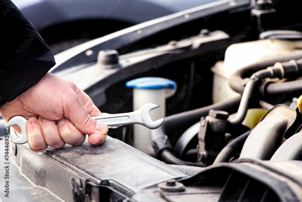 Maintenance and repair, auto mechanic, hand and wrench for car repair, engine problem and diagnosis, car repair