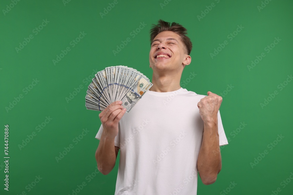 Happy man with dollar banknotes on green background Happy man with dollar banknotes on green background