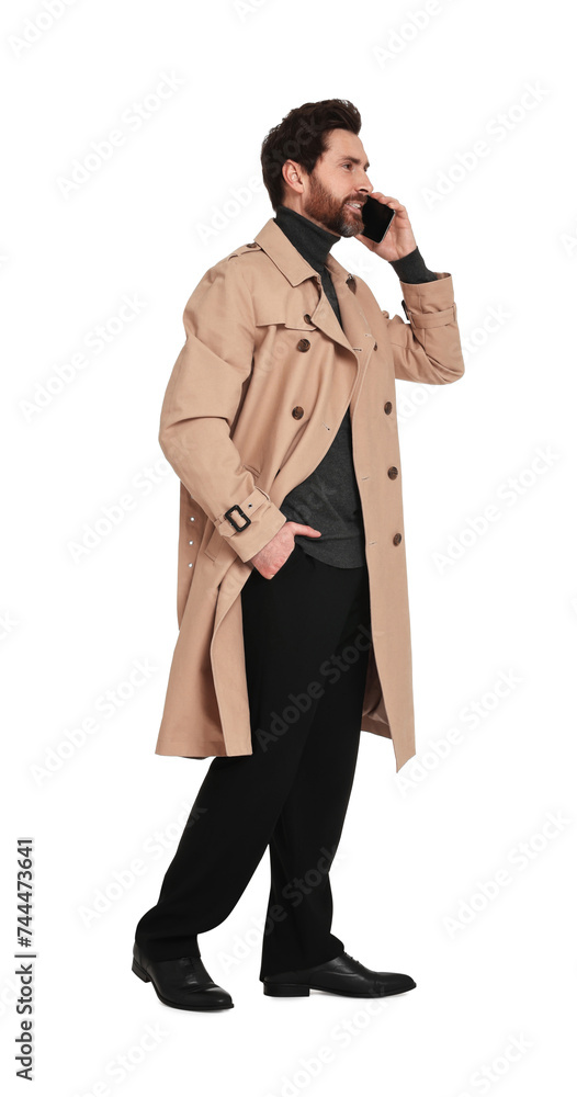 Handsome man talking on phone against white background Handsome man talking on phone against white background