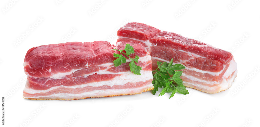 Pieces of raw pork belly and parsley isolated on white Pieces of raw pork belly and parsley isolated on white