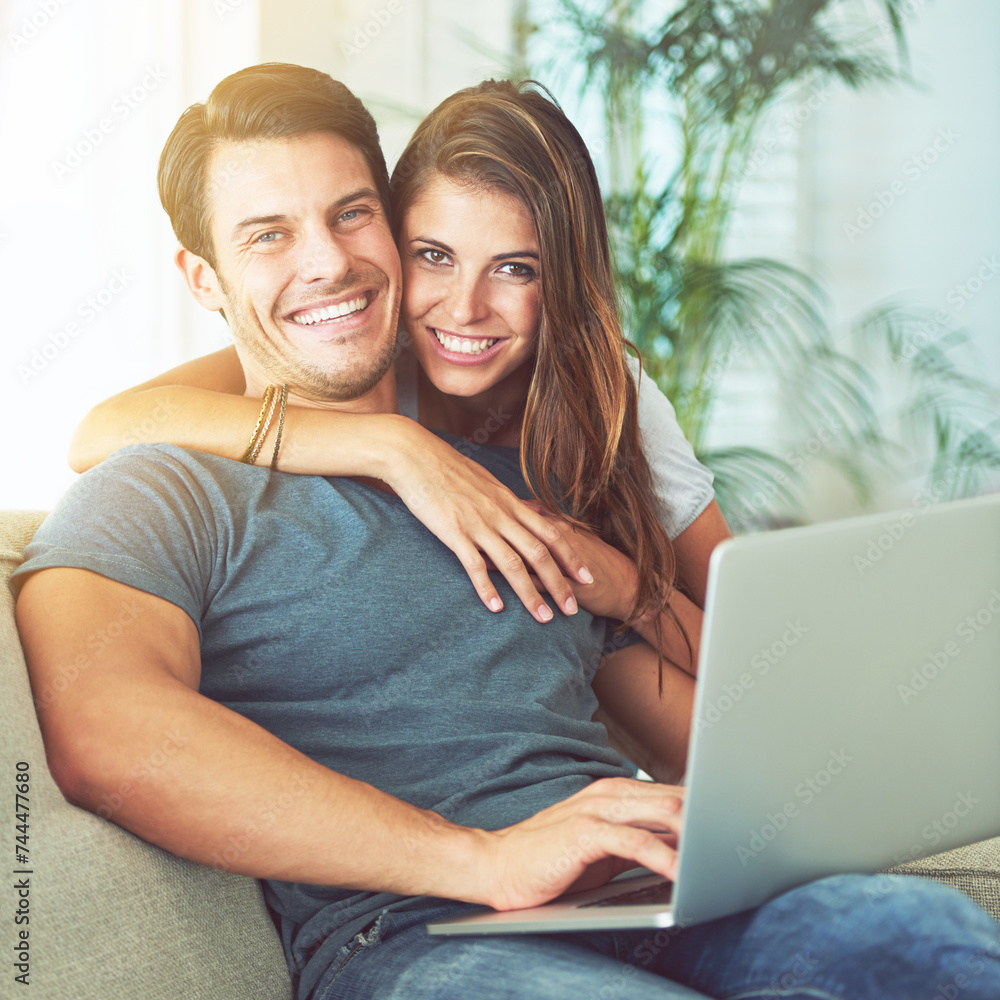 Laptop, smile and woman embrace man on sofa networking on social media, website or internet. Happy, love and female person hugging husband reading online blog with computer in living room at home.