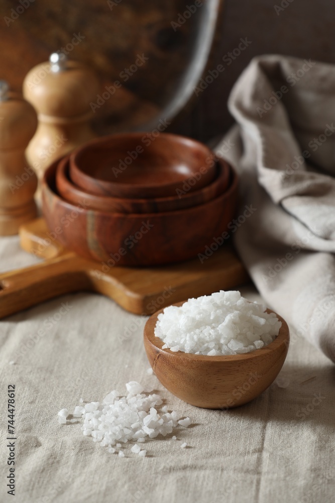 Organic salt in wooden bowl on table Organic salt in wooden bowl on table
