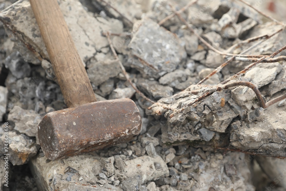 Sledgehammer on pile of broken stones outdoors, closeup Sledgehammer on pile of broken stones outdoors, closeup