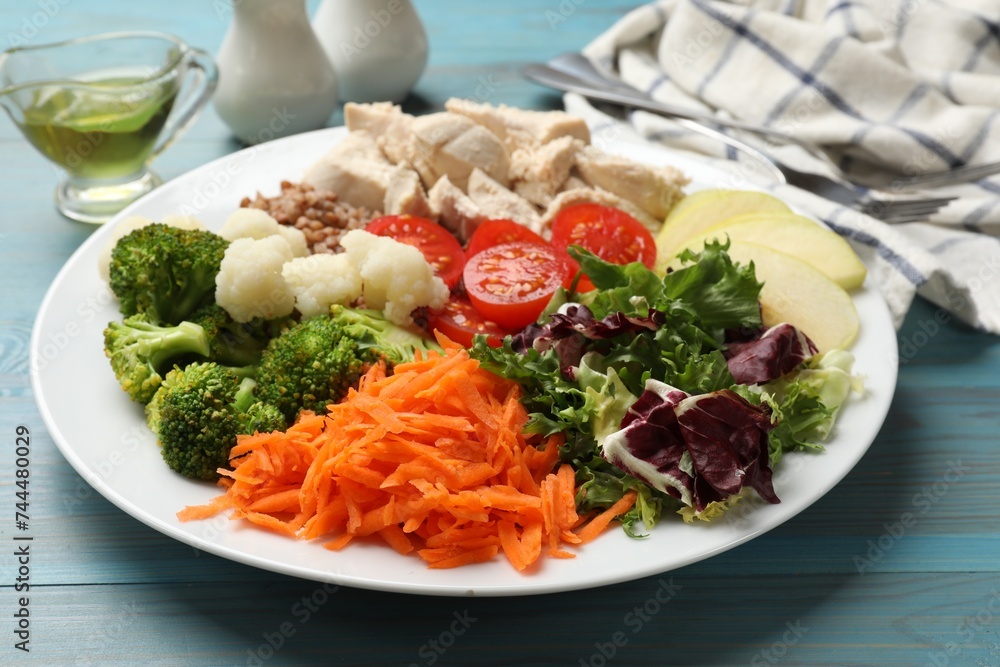 Balanced diet and healthy foods. Plate with different delicious products on blue wooden table, closeup Balanced diet and healthy foods. Plate with different delicious products on blue wooden table, closeup