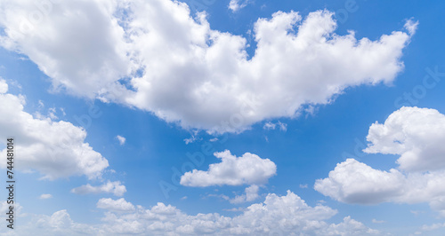 Panoramic view of clear blue sky and clouds, Blue sky background with tiny clouds. White fluffy clouds in the blue sky. Captivating stock photo featuring the mesmerizing beauty of the sky and clouds. © pinglabel