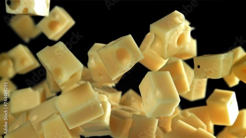 Super slow motion pieces of cheese on black background. Filmed on a high-speed camera at 1000 fps. High quality FullHD footage photo