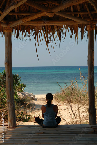 Yoga meditation outdoor under gazebo in full lotus position at the beach