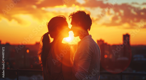 Romantic Couple Silhouetted Against Sunset. Silhouette of a romantic couple close together with sunset backdrop.