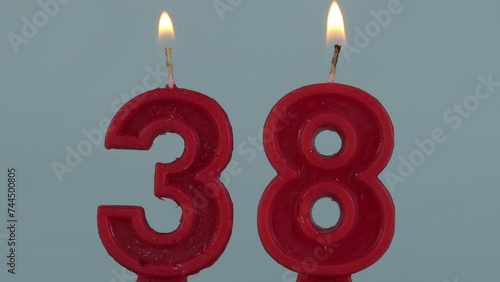 close up on a red number thirthy eighth birthday candle on a white background.
 photo