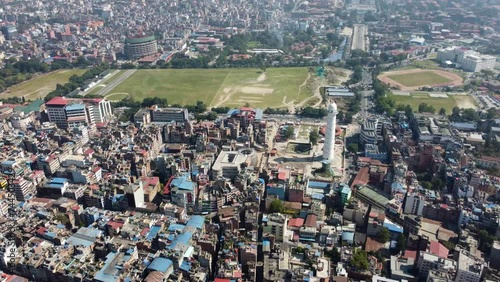 Aerial view of Kathmandu city, Nepal, showcasing the densely packed buildings and the majestic Himalayan mountains in the background.