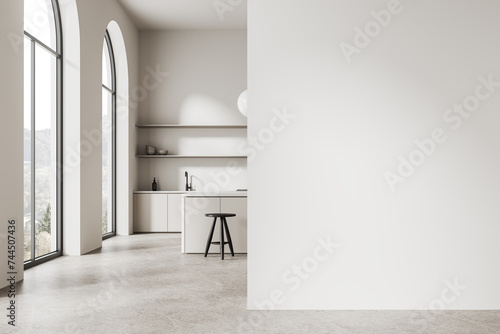 White kitchen interior with island and blank wall