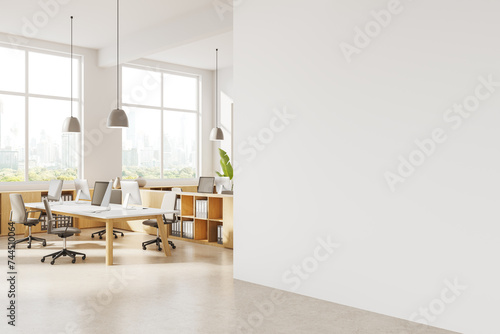 Modern white coworking office corner with blank wall