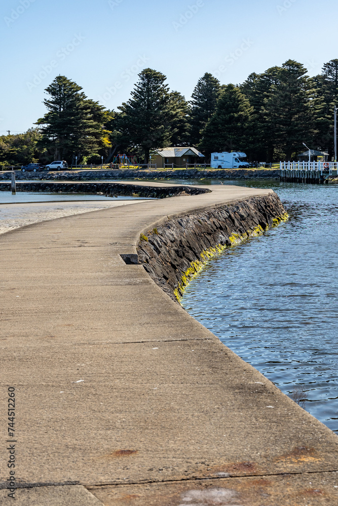 The casueway leading across to Griffiths Island Lighthouse in Port Fairy Victoria Australia on October 2nd 2023