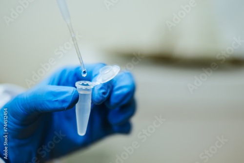 Scientist Transferring Liquid Sample into Eppendorf Tube with Micropipette