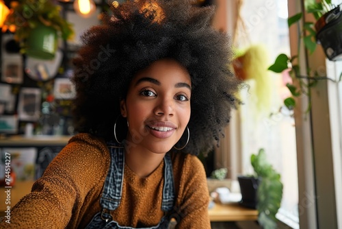Young African American hipster woman with Afro hair looking at webcam talking to camera with friend online sitting at cafe table making video call, virtual chat, recording blog, Generative AI