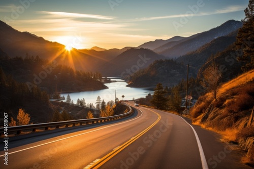 Scenic view of beautiful lake and winding road at sunset, tranquil nature landscape setting