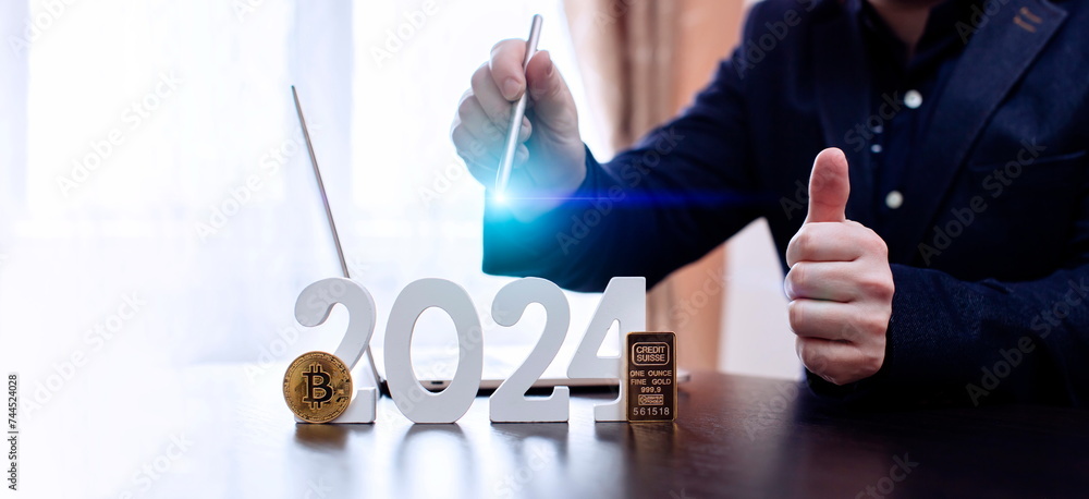 businessman buys gold and bitcoin in 2024 using digital technology and laptop computer. Finance and trade concept 2024. businessman buys gold and bitcoin in 2024 using digital technology and laptop computer. Finance and trade concept 2024.