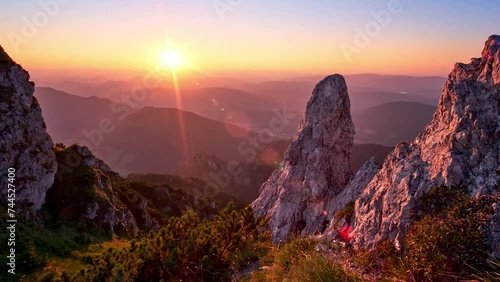 Sunset in a hilly summer landscape, rocks and rhombus illuminated by the setting sun, cloudless sky photo