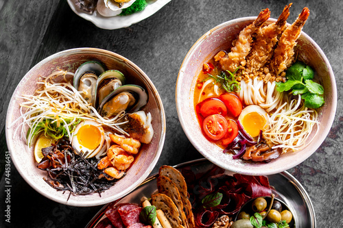 two bowl with noodles ramen in spicy soup with shrimps