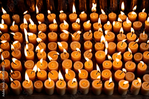 Many burning wax candles in orthodox church or temple for ceremony easter. Background orange candles easter burn in orthodox temples. Concept of church backgrounds for creativity. Copy space for site