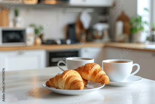 Two cups of coffee and fresh croissant on white table