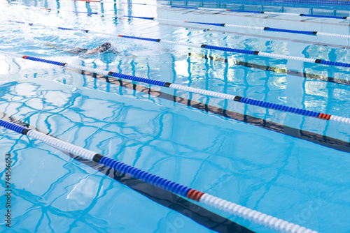 Swimmer in action at a competitive pool event, with copy space