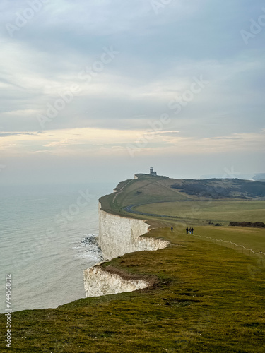 Eastbourne  England  UK. Belle Tout Lighthouse view from Seven Sisters cliffs in East Sussex. Cliff walking path view from Beachy Head to Birling Gap in Southern England.