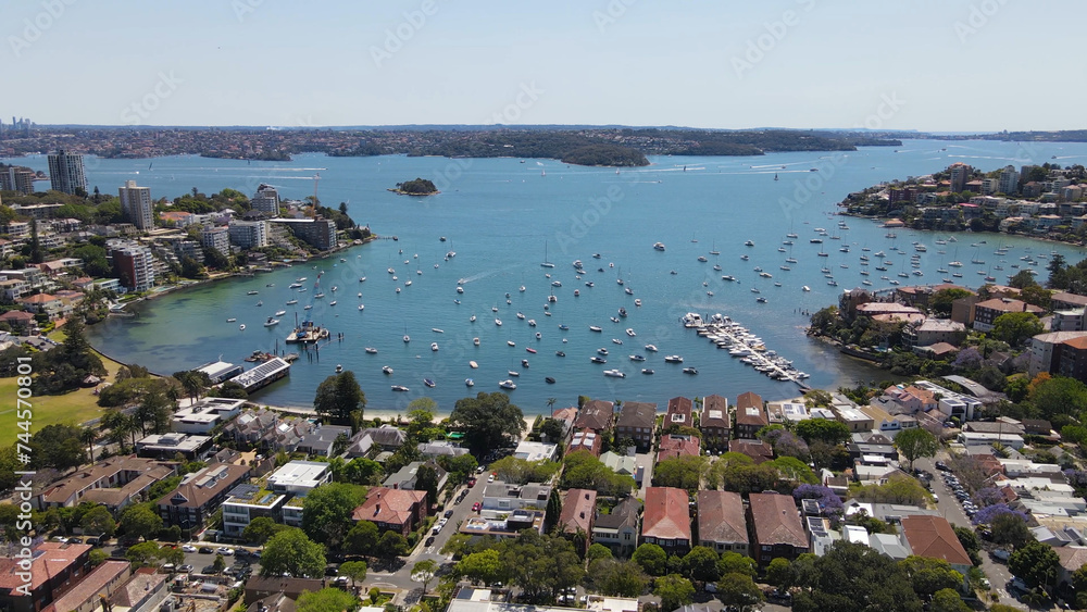 Aerial drone view of homes and streets above the harbourside suburb of Double Bay in east Sydney, NSW Australia looking toward Sydney Harbour on a sunny day