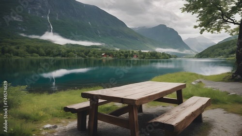 Picnic wooden bench table near lake in the mountains