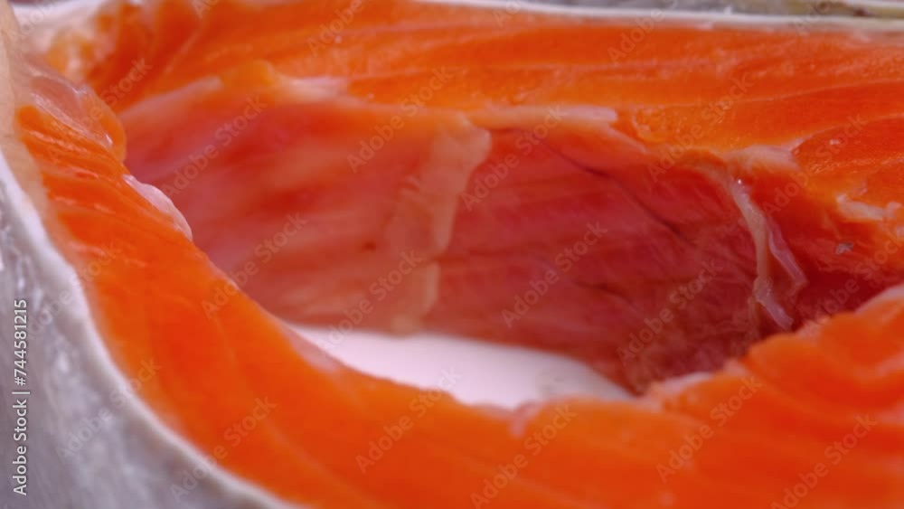 Two salmon steaks rotate slowly, on a white background, close-up. Salmon texture. Seafood.Trout Steak macro food video Two salmon steaks rotate slowly, on a white background, close-up. Salmon texture. Seafood.Trout Steak macro food video