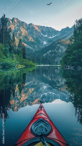 Kayaking at Sunrise in Mountain Lake Scenery © happysunstock