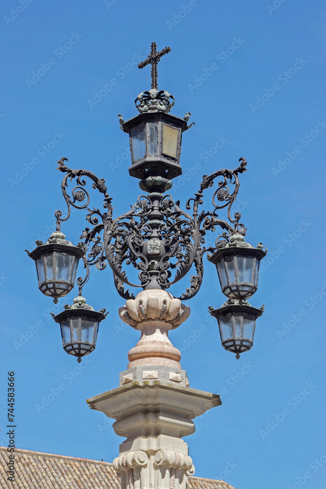 lamp in blue sky at Cathedral church in Seville, Spain 