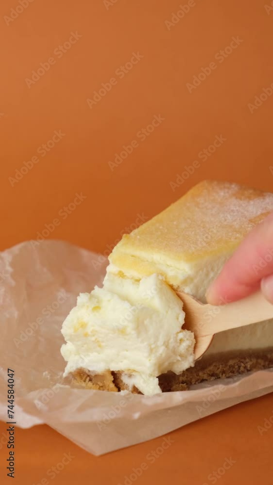 A woman's hand cuts a cheesecake with a fork. delicious cottage cheese cheesecake A woman's hand cuts a cheesecake with a fork. delicious cottage cheese cheesecake