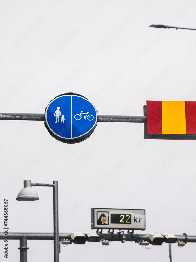 Pedestrian and Cyclist Signage Next to a Red and Yellow Barrier in Gothenburg, Sweden, on a Cloudy Day Pedestrian and Cyclist Signage Next to a Red and Yellow Barrier in Gothenburg, Sweden, on a Cloudy Day