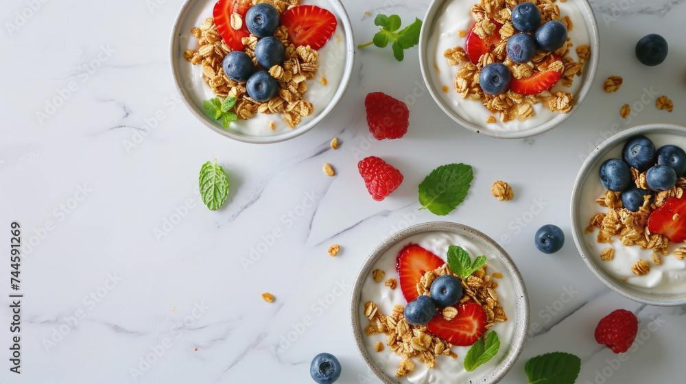 Fresh and colorful bowls of yogurt with berries and mint leaves