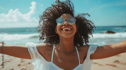 one young woman at the beach with openened arms enjoying free time and freedom outdoors. Having fun relaxing and living happy moments. #744599605
