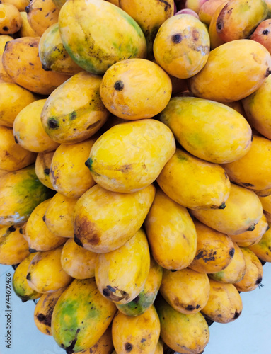 Sticker Ripe mango fruit organic raw yellow juicy sweet mangoes heap closeup mangos mang
