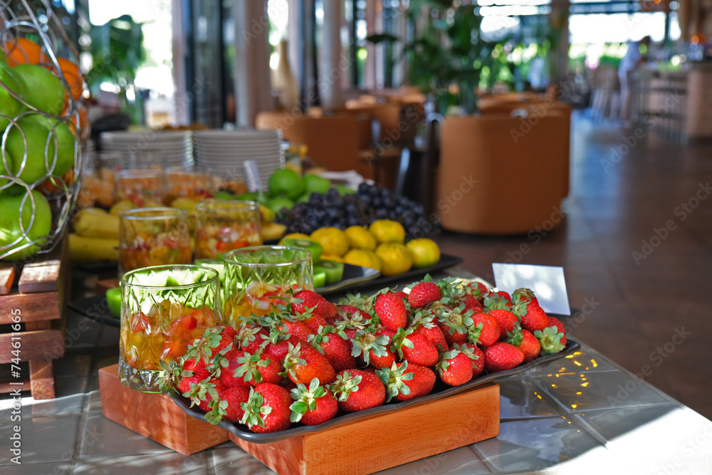In the open buffet breakfast service, the strawberry plate is in the foreground and other fruit plates are in the background.