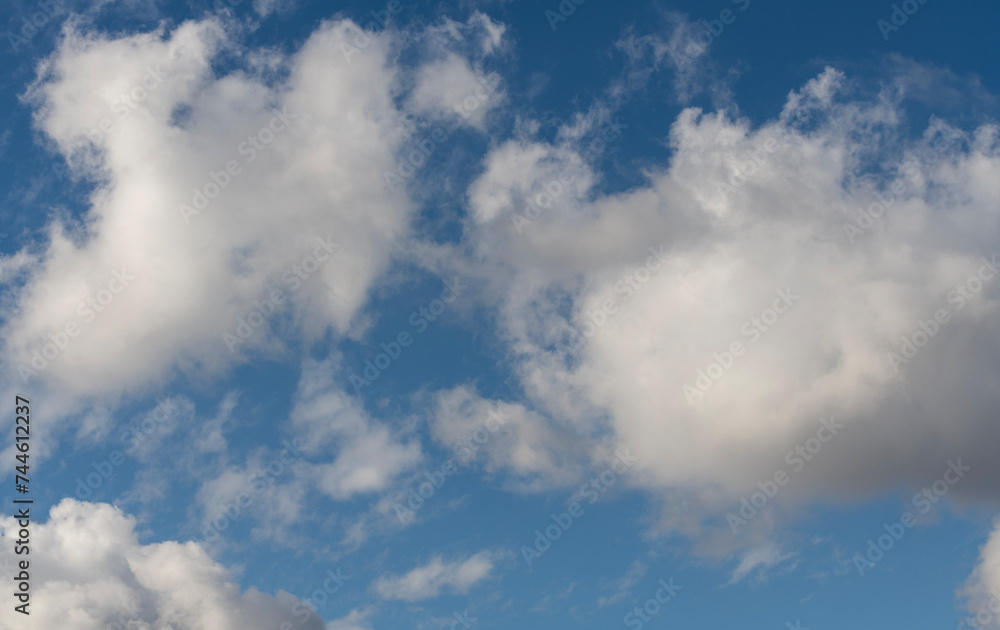 Beautiful bright blue sky with fluffy white clouds.