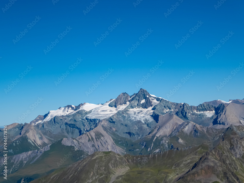 Panoramic view of majestic mountain peak Grossglockner seen from Hochschober, Schober Group, High Tauern, East Tyrol, Austria. Wanderlust Austrian Alps in summer. Rugged ridges against clear blue sky Panoramic view of majestic mountain peak Grossglockner seen from Hochschober, Schober Group, High Tauern, East Tyrol, Austria. Wanderlust Austrian Alps in summer. Rugged ridges against clear blue sky