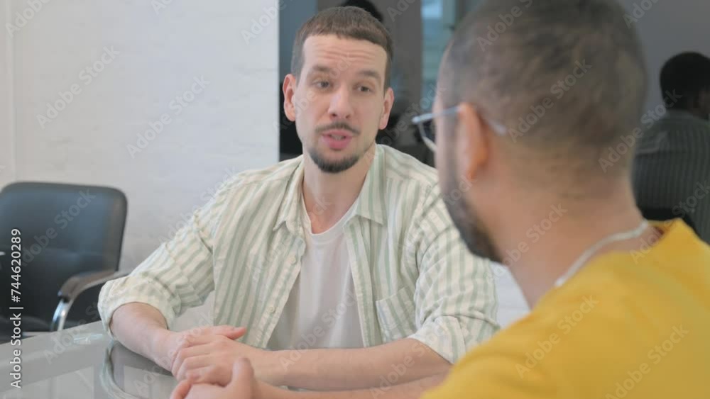 Close up of Young Man Talking with Colleague Close up of Young Man Talking with Colleague