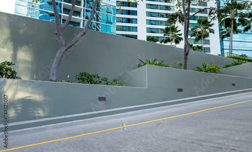 Εκτύπωση καμβά Gray Inclined Planter Boxes with Green Foliage in an Urban Background