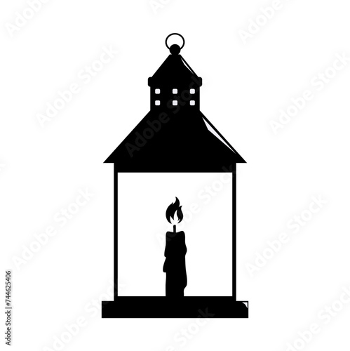 silhouette of a lantern with a burning candle