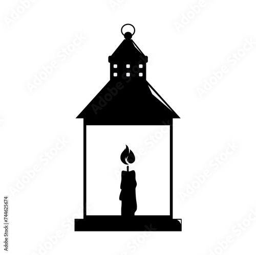 silhouette of a lantern with a burning candle