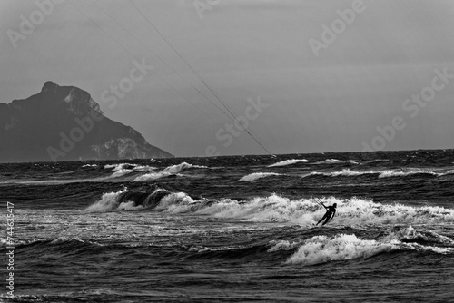 kite surfers ride the waves. Winter sport with high waves and many dangers. Wind and wave speed. Men and women do extreme sports People water sport 
