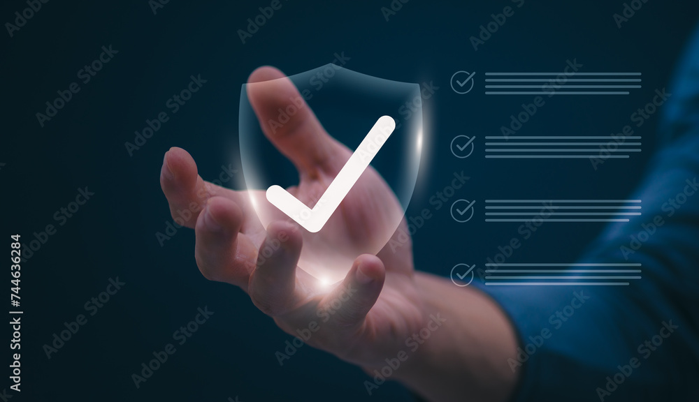 Male hand pointing at symbol of guarantee of quality of service Certification concept and standard quality control Standard warranty Documents certified on virtual screen Male hand pointing at symbol of guarantee of quality of service Certification concept and standard quality control Standard warranty Documents certified on virtual screen