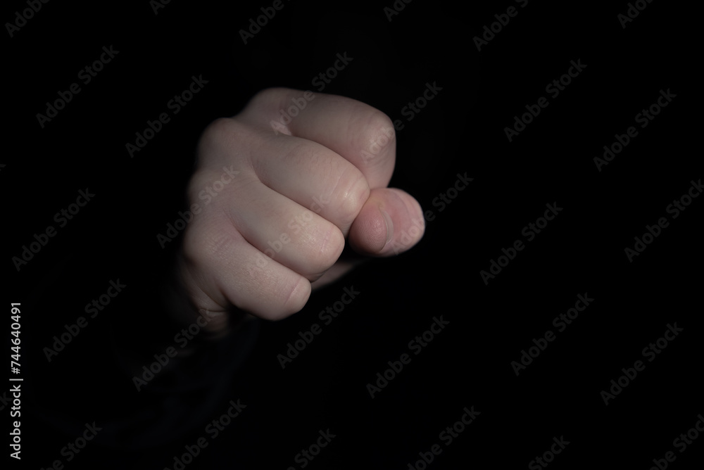 Striking fist in the darkness. Violence concept. Striking fist in the darkness. Violence concept.