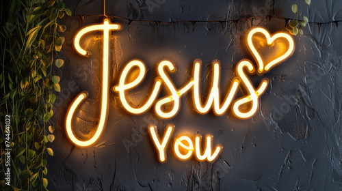 Illuminated Yellow Neon Sign as Wall Fixture Declaring Jesus Loves You, with Heart Shape Symbol / Icon and Dark Grey Background and Dim Lighting
