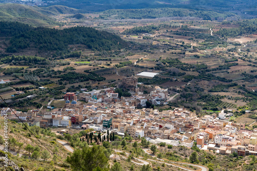 aerial image of a small village surrounded by mountains and nature